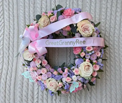 18 inch floral wreath tribute with white flowers and greenery