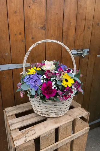 Basket of Blooms flower arrangement in wicker basket